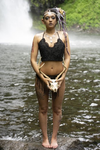 Woman Standing on Rock Near Flowing Water