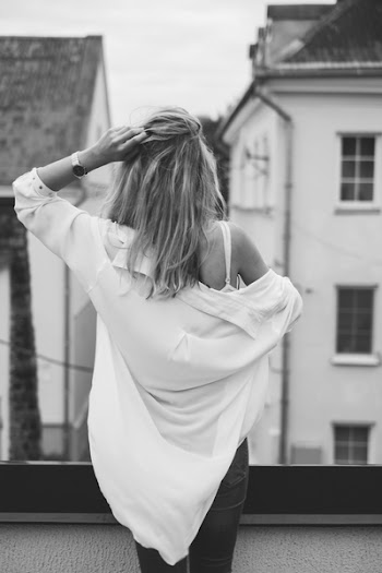 Woman Standing on Rooftop Facing Buildings