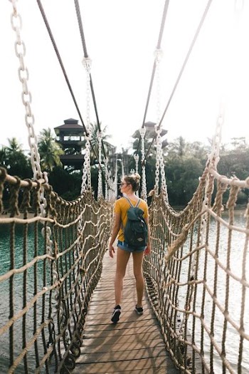 woman standing on rope made bridge