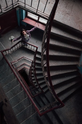 Woman Standing on Staircase With A Bouquet