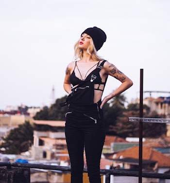 Woman Standing on the Rooftop Overlooking Houses