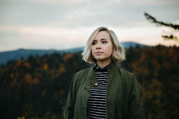 woman standing on top of mountain