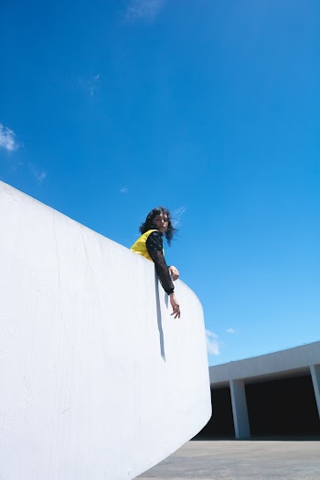 Woman Standing on Top of White Building