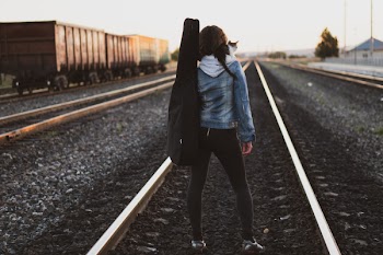 Woman Standing on Train Rail