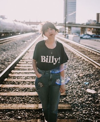 woman standing on train rail