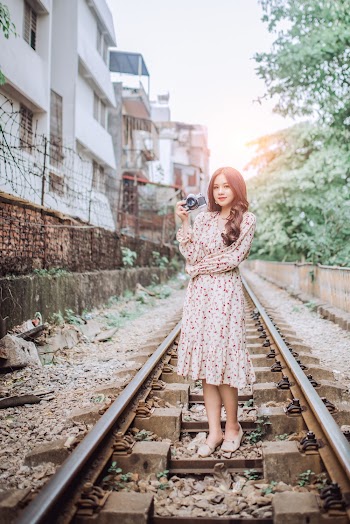 Woman Standing on Train Rail