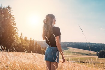 Woman Standing on Wheat Field