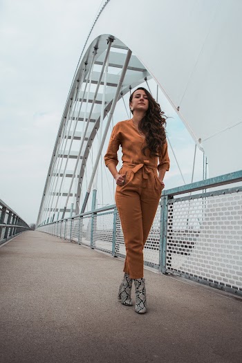 Woman Standing on White Arch Bridge