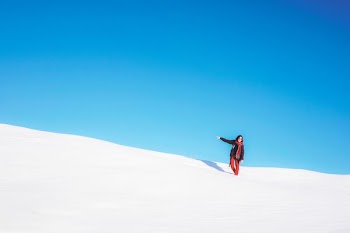 woman standing on white snow field during daytime