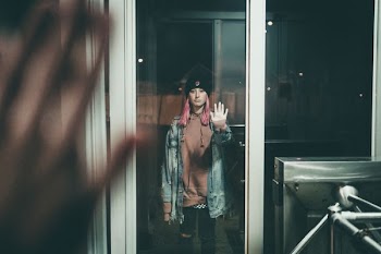 woman standing on window during daytime