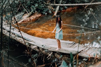 Woman Standing on Wooden Bridge
