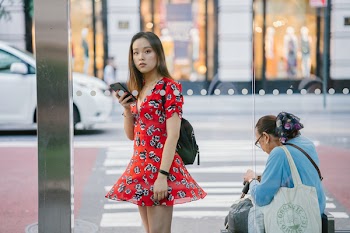 Woman Standing Outdoor Holding Smartphone