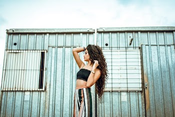 Woman Standing Outdoors While Right Hand Touching Head