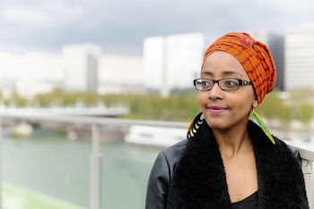Woman Standing Outside With Background of Buildings