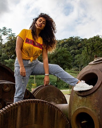 Woman Standing over Brown Metal Machines