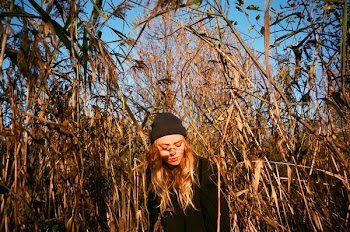 Woman Standing Surrounded by Plants