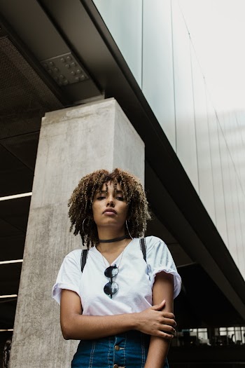 Woman Standing Under a Concrete Building