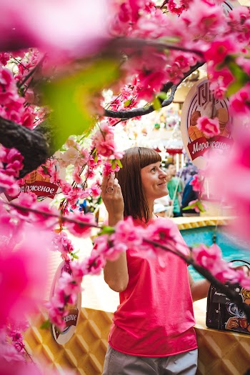 Woman Standing Under Flowering Tree