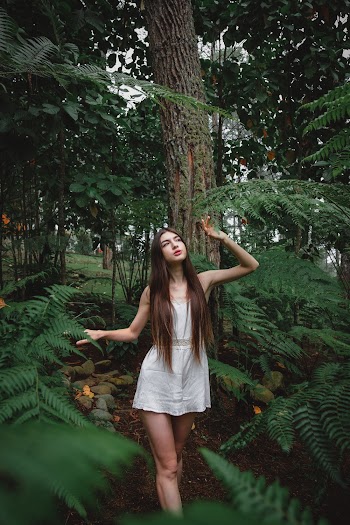 Woman Standing Under Forest Trees and Plants While Wearing White Sleeveless Minidress
