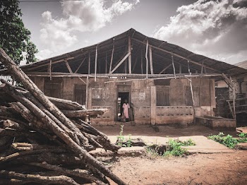 Woman Standing Under Roof