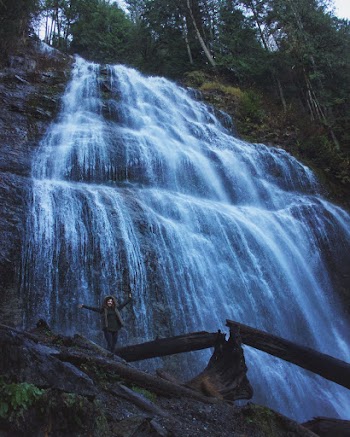 Woman Standing Under Waterfalls