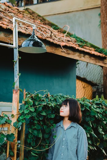 Woman Standing Underneath Pendant Lamp