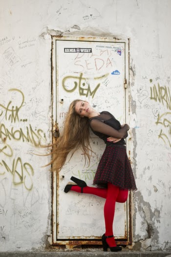 Woman Standing Using Right Foot in Front of Closed White Door