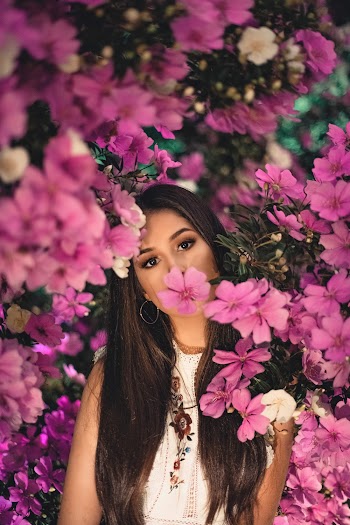 Woman Standing Wearing White Shirt Surrounded of Pink Petaled Flower