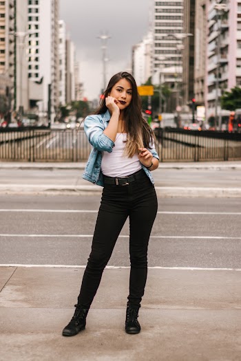 Woman Standing Wearing White Top and Black Pants