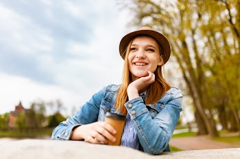 Woman Standing While Holding Cup of Coffee