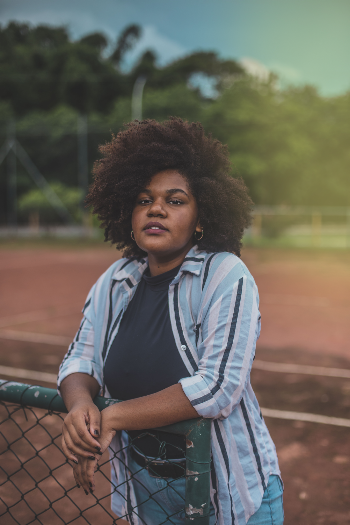 Woman Standing While Holding Green Fence