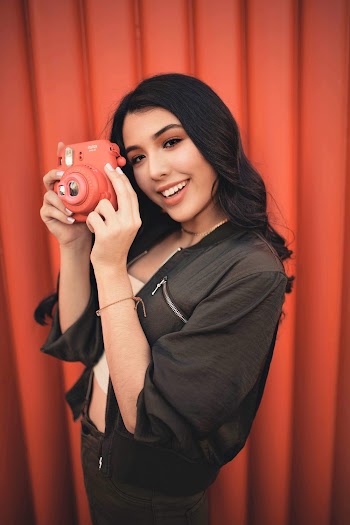 Woman Standing While Holding Red Instax Mini Camera