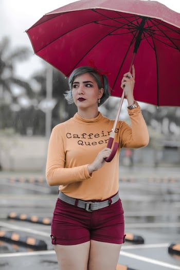 Woman Standing While Holding Umbrella