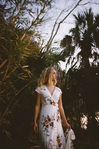 woman standing while looking sideways in forest