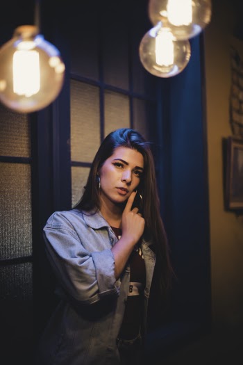Woman Standing With Window on Background
