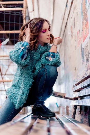 Woman Stepping on Wooden Bench While Touching Her Hair