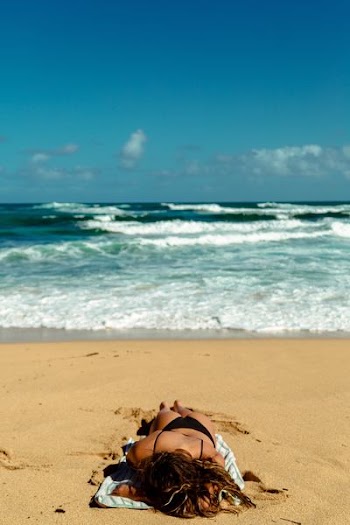 woman sunbathing on beach