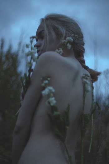 Woman Surrounded by Flowers