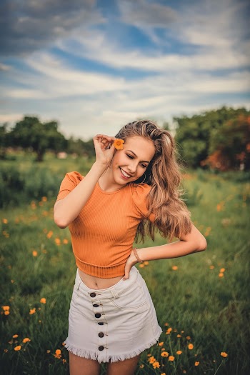 Woman Surrounded by Grass and Flowers