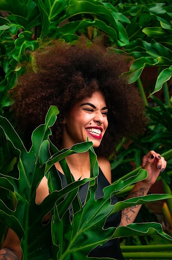 Woman Surrounded by Green-Leafed Plants