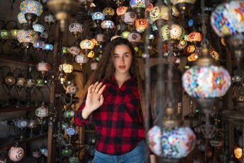 Woman Surrounded by Mosaic Glass Lanterns