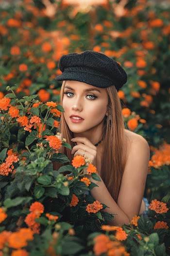 Woman Surrounded by Orange-petaled Flowers