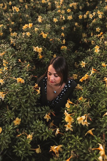 Woman Surrounded by Yellow Flowers