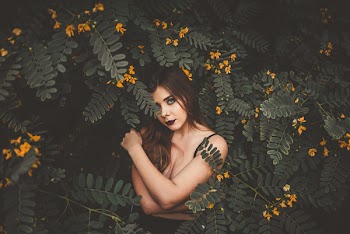Woman Surrounded Green Plants While Posing