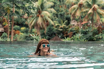 Woman Swimming Wearing Green Sunglasses