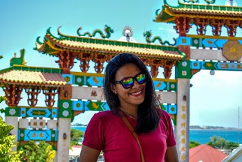 Woman Takes Photo in Front Temple Gates