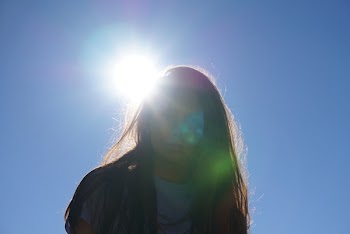 Woman Takes Photo Under the Sun