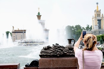 Woman Taking A Picture Of Fountain