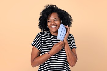 Woman taking mask off  during the new normal | Free stock photo | High Resolution image