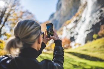 Woman Taking Mobile Photograph